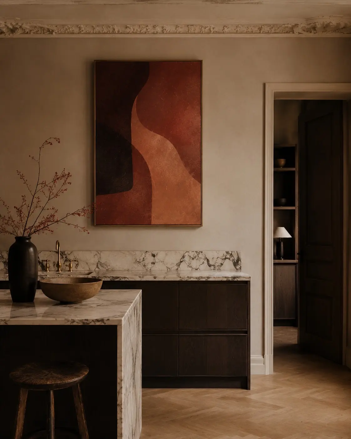 Warm abstract painting in terracotta and black curves, above a marble counter