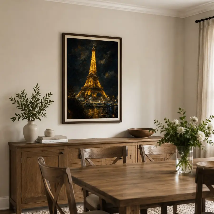 An oil painting of the Eiffel Tower at night, framed above an oak sideboard