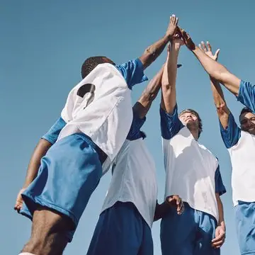Footballers giving each other a high five after the match